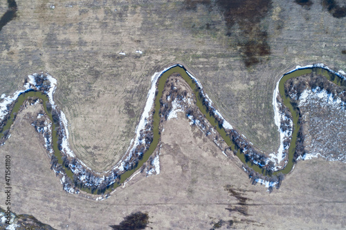 Obraz na płótnie Top view of river running through bare farmland w salonie