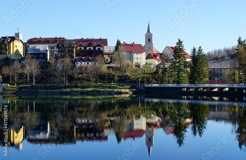 Picturesque small town landscape with reflection in lake water