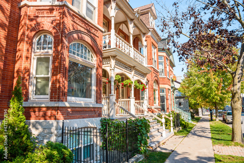 Wallpaper Mural Traditional red brick residential buildings with stairs leading up to the front doors along a tree lined street on a sunny autumn day Torontodigital.ca