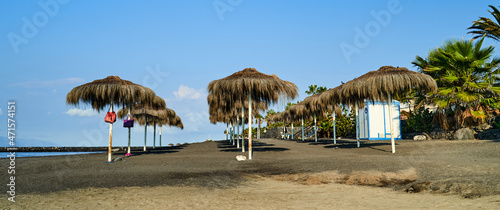 Sun umbrellas on the beach of Playa El Beril, Costa Adeje, Tenerifa photo