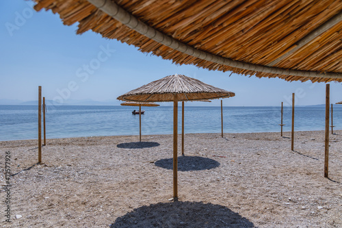 Fototapeta Naklejka Na Ścianę i Meble -  Empty beach in Benitses town on the Ionian Sea shore on Corfu Island, Greece