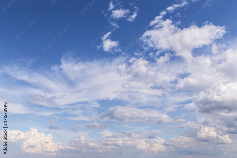 Blue sky with beautiful white cirrus and cumulus clouds in sunlight background texture Blue sky with beautiful white cirrus and cumulus clouds in sunlight background texture