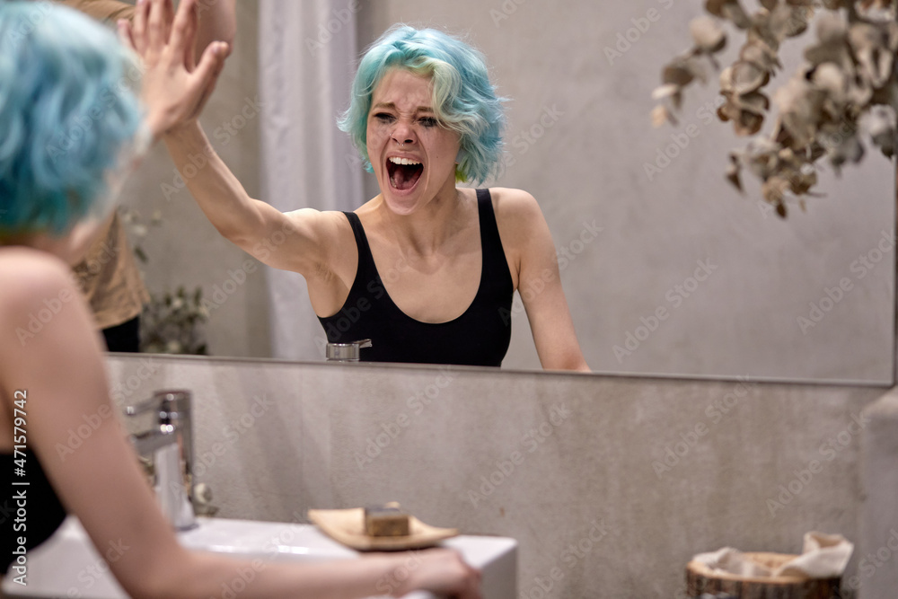 young caucasian unhappy woman emotionally screaming near bathroom mirror, having stress, problems. at home alone. human emotions, break up, divorce, crisis, desperate situation concept young caucasian unhappy woman emotionally screaming near bathroom mirror, having stress, problems. at home alone. human emotions, break up, divorce, crisis, desperate situation concept