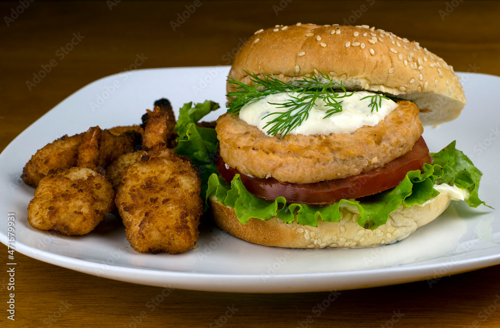 salmon burger top with tater sauce and dill salmon burger top with tater sauce and dill
