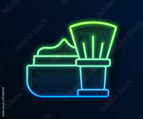 Glowing neon line Shaving brush with foam icon isolated on blue background. Barbershop symbol. Vector