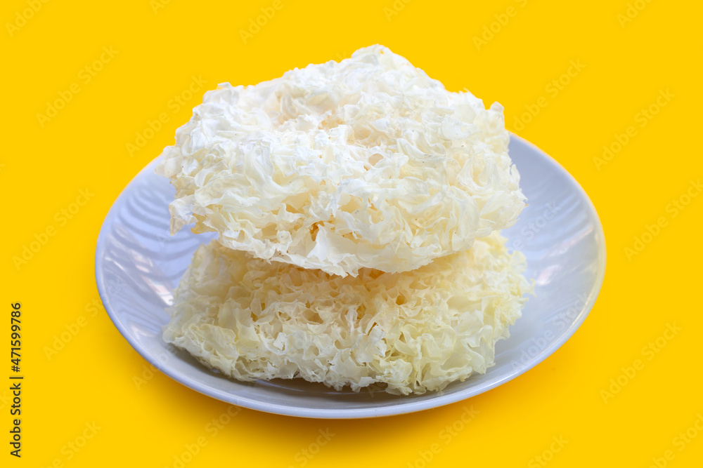 Tremella Mushroom on white plate on yellow background. Tremella Mushroom on white plate on yellow background.