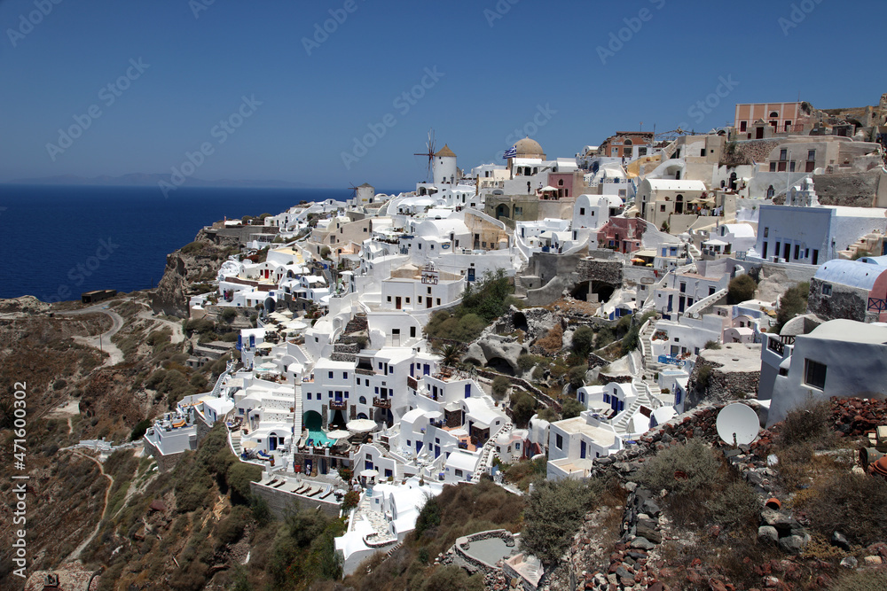 Oia Town and windmill at beautiful Greek island Santorini in Greece. Oia is a small town and former community in the South Aegean on the Santorini.