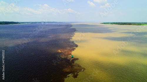 Manaus, Amazon. Connection of two streams of rivers with different density and color. photo