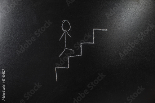 stickman climbing stairs on blackboard background © Bilal