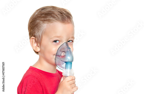 the little boy in the inhalation mask is smilling