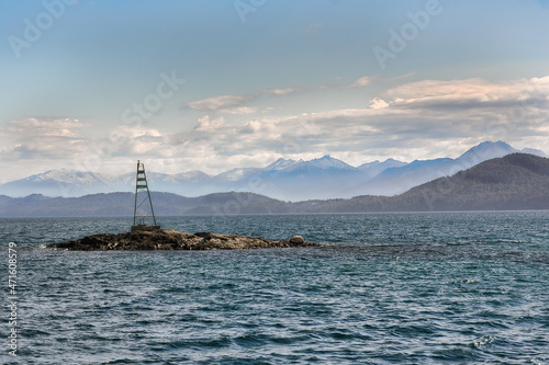 buoy over lake with background mountains and clouds