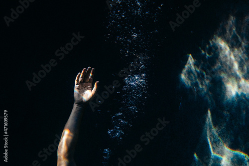 Hand under water reaching
