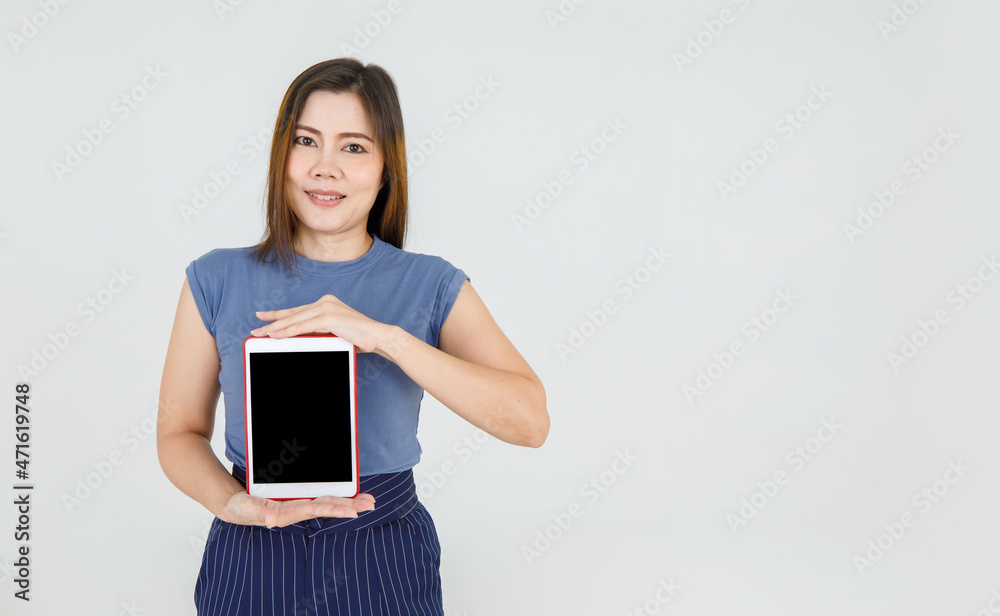 Charming Asian mature woman proud to present attractive promotion for advertising smart tablet for online communication. Beautiful lady show comfortable device and explain technology Charming Asian mature woman proud to present attractive promotion for advertising smart tablet for online communication. Beautiful lady show comfortable device and explain technology