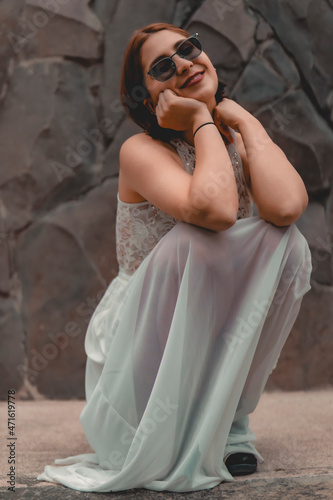 Chica agachada en vestido blanco 