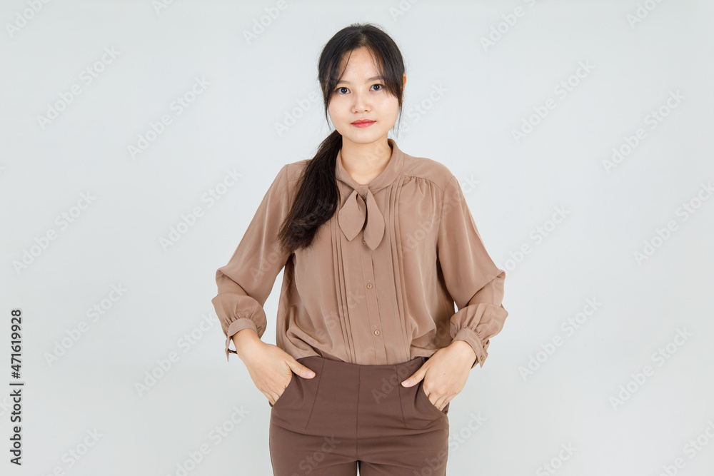 Lovely Asian girl cheerfully smile as friendly emotion and confident while standing with happy face and attractive charming brown blouse as pretty casual outfit for female lifestyle. Lovely Asian girl cheerfully smile as friendly emotion and confident while standing with happy face and attractive charming brown blouse as pretty casual outfit for female lifestyle.