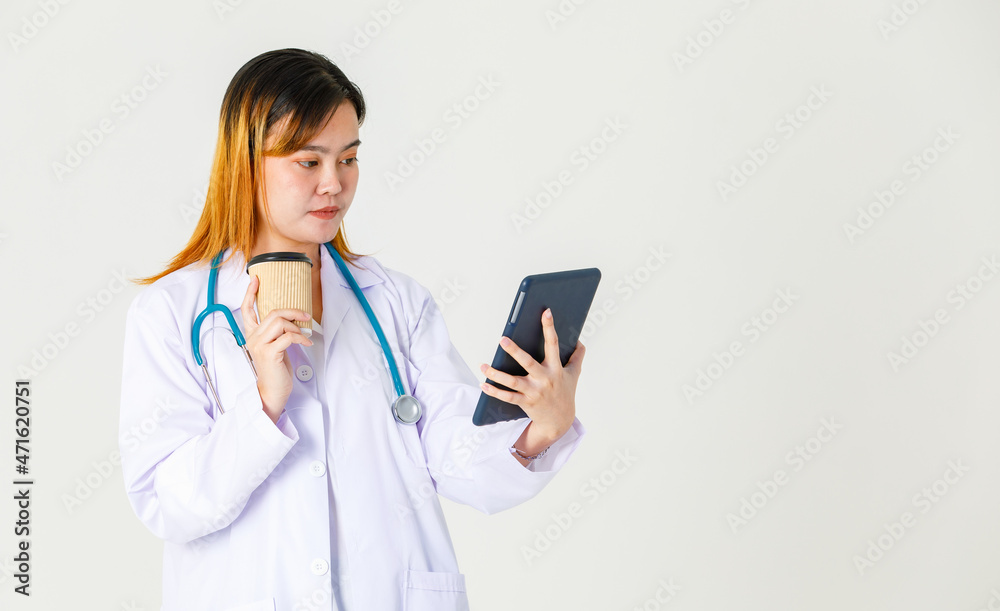 Studio shot of Asian successful professional confident female doctor in lab coat uniform hanging stethoscope around neck take coffee break standing smiling holding tablet computer on white background Studio shot of Asian successful professional confident female doctor in lab coat uniform hanging stethoscope around neck take coffee break standing smiling holding tablet computer on white background