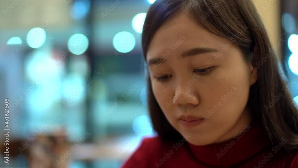 Woman eating a hamburger in fast food restaurant. Woman eating a hamburger in fast food restaurant.