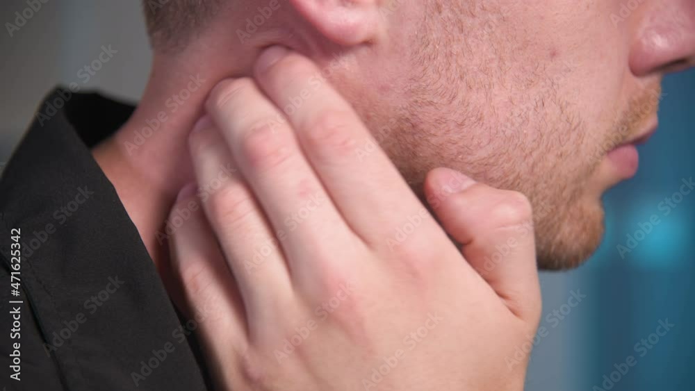 Young Caucasian male masseur doing self-neck massage to himself. Close-up. Myofasceal release Young Caucasian male masseur doing self-neck massage to himself. Close-up. Myofasceal release