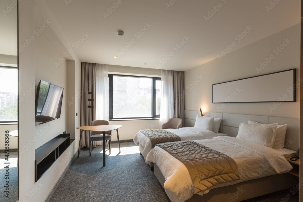 Interior of a luxury double bed hotel bedroom in the morning Interior of a luxury double bed hotel bedroom in the morning