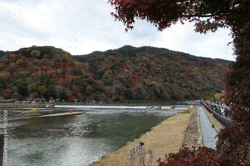 A view of Oi-gawa River and red leaves from Togetsu-kyo Bridge at Arashiyama in Kyoto City in Japan 日本の京都市嵐山にある大堰川の渡月橋から見た秋の風景