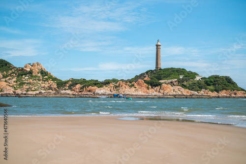Scenic view of the lighthouse on the beautiful shore with large stones. The beauty of nature. Amazing places in the world. bay with crystal water
