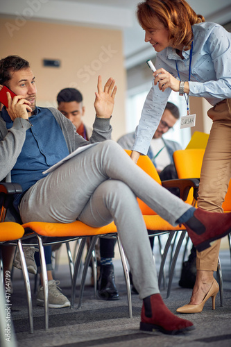 Man talking on the phone on presentation in the conference room