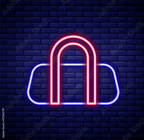 Glowing neon line Sport bag icon isolated on brick wall background. Colorful outline concept. Vector