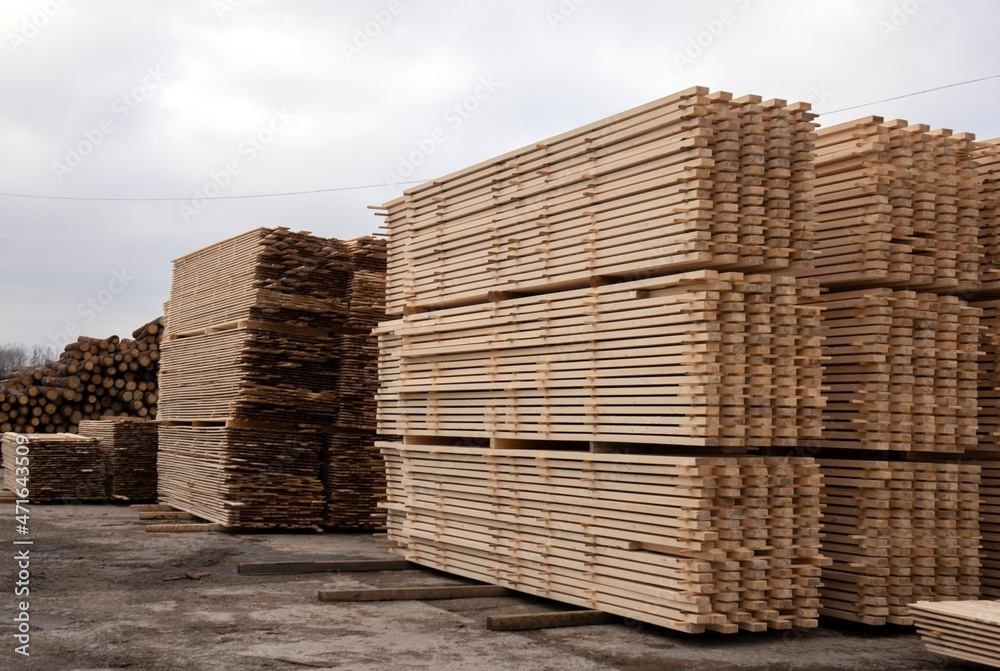 Lumber warehouse. Wooden boards in a stack Lumber warehouse. Wooden boards in a stack