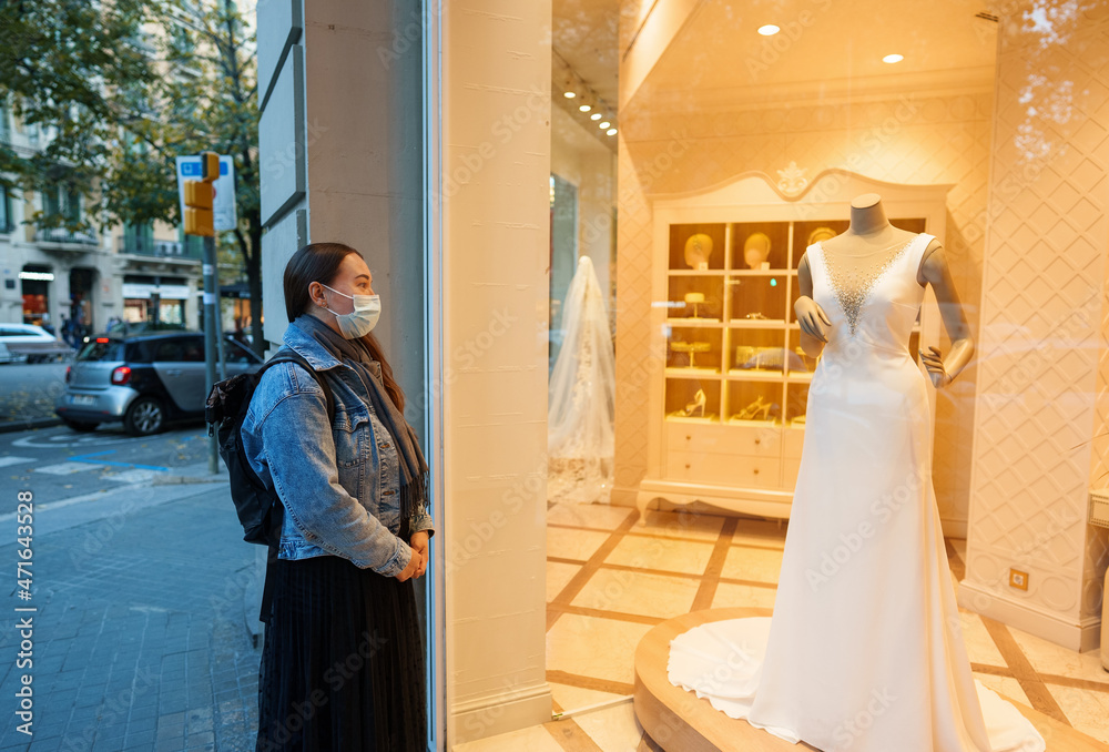 Woman dreaming about expensive wedding dress