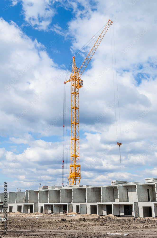 Tall cranes and building of houses