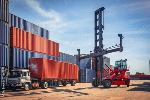 In shipping containers, there is a crane that lifts up the upper container. 