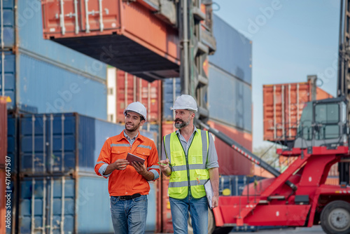 Engineer male double-checks the security system configuration and inspects logistic freight containers. 