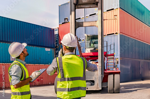 Engineer male double-checks the security system configuration and inspects logistic freight containers. 