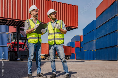 Engineer male double-checks the security system configuration and inspects logistic freight containers. 