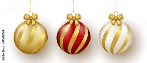 Christmas and New Year decor. Set of gold, white and red glass ornament balls on ribbon with bow.