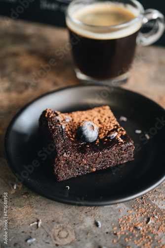 Chocolate brownie with blueberry on dark background