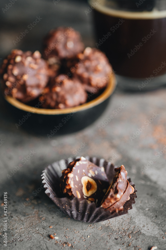 Handmade chocolate ferrero rocher in plate at dark background