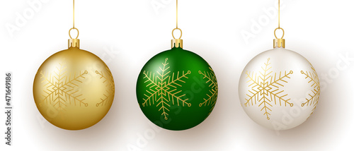 Christmas and New Year decor. Set of gold, white and green snowflake ornament balls on ribbon.