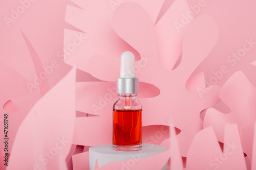 Dropper glass bottles with pipette standing on a white podium. Transparent hyaluronic natural beauty mineral product and eco serum skin care concept.
