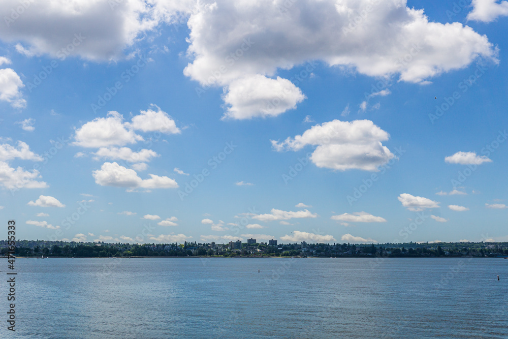 fantastic city view across the bay with blue sky and white clouds