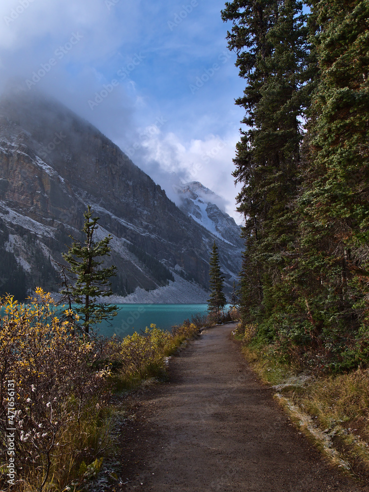 View of the shore of popular Lake Louise in Banff National Park, Alberta, Canada in the Rocky Mountains in autumn season in the morning.