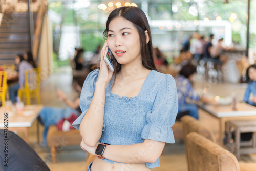 Business women use smartphone in coffee shop