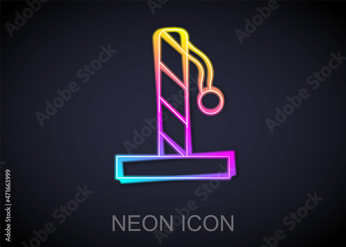 Glowing neon line Cat scratching post with toy icon isolated on black background. Vector