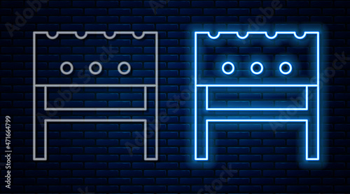 Glowing neon line BBQ brazier icon isolated on brick wall background. Vector