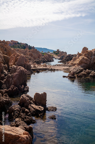 Beautiful stone coast splashed by seawater. Look on an open sea.