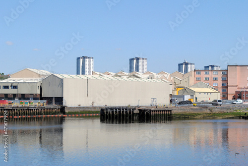 River View of Riverside Industrial Buildings seen against Blue Sky 