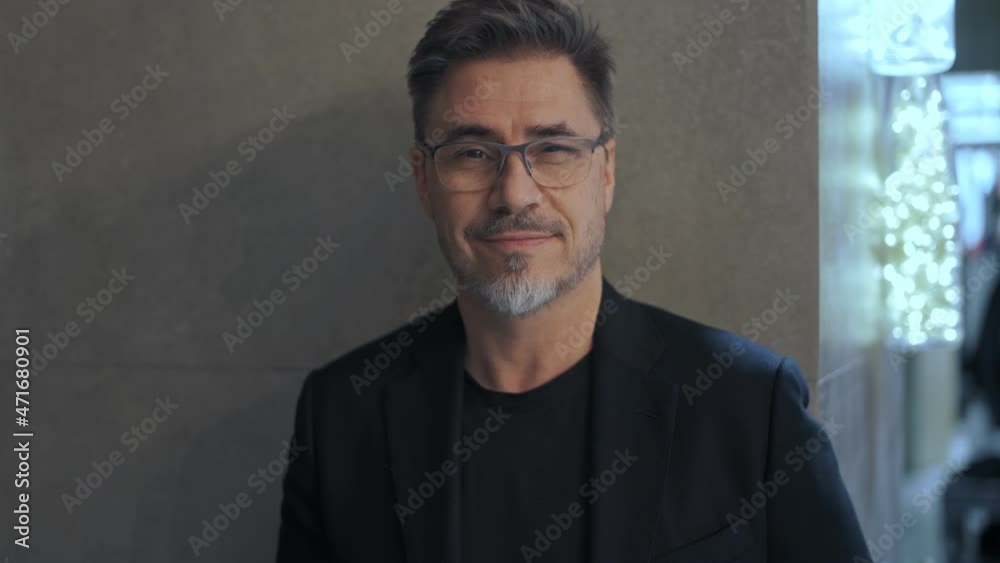 Business portrait - happy smiling businessman at office wearing glasses. Mature age, middle age, mid adult man in 50s, white caucasian, Business portrait - happy smiling businessman at office wearing glasses. Mature age, middle age, mid adult man in 50s, white caucasian,