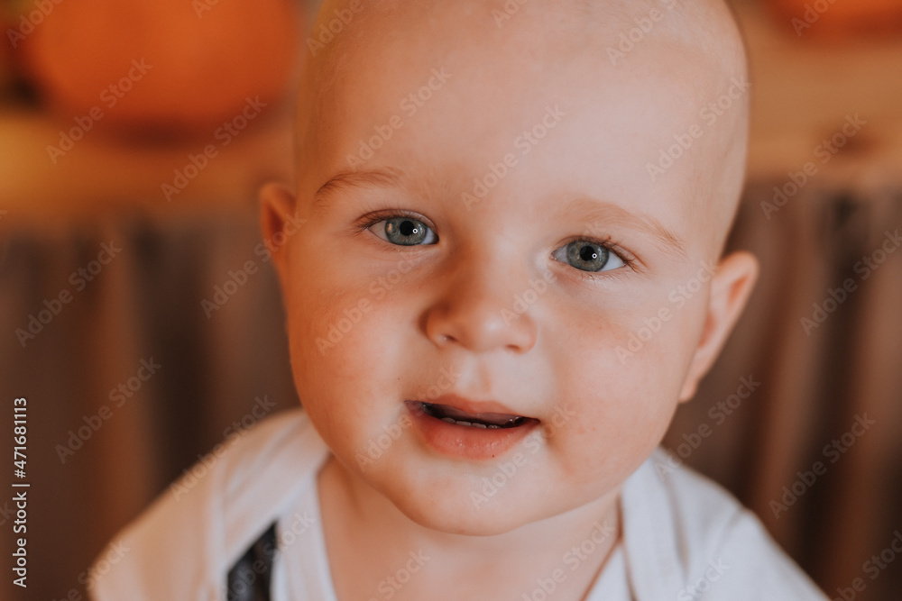 closeup portrait of a cute smiling one-year-old baby with blue eyes. little boy in a T-shirt with the number one. first birthday in a festive atmosphere. High quality photo closeup portrait of a cute smiling one-year-old baby with blue eyes. little boy in a T-shirt with the number one. first birthday in a festive atmosphere. High quality photo