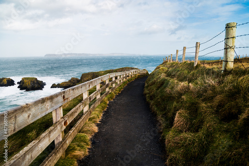 A stunning trekking path in Giant's Causeway, Northern Ireland. An ideal destination for hiking and exploring a geological wonder. A UNESCO World Heritage Site
