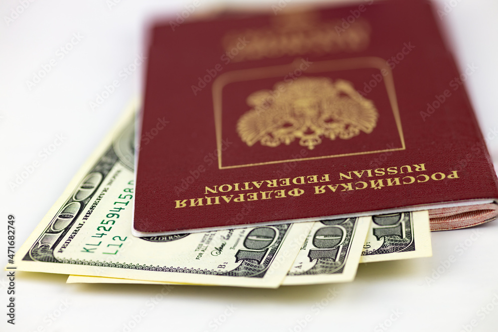 Russian passport and American dollars, macro, close-up, selective focus. Russian passport and American dollars, macro, close-up, selective focus.